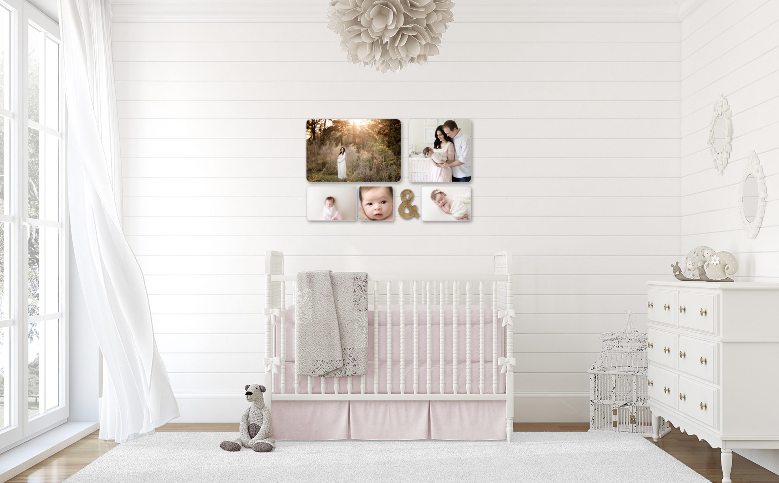 artwork hung over baby's crib with gray blanket and teddy bear