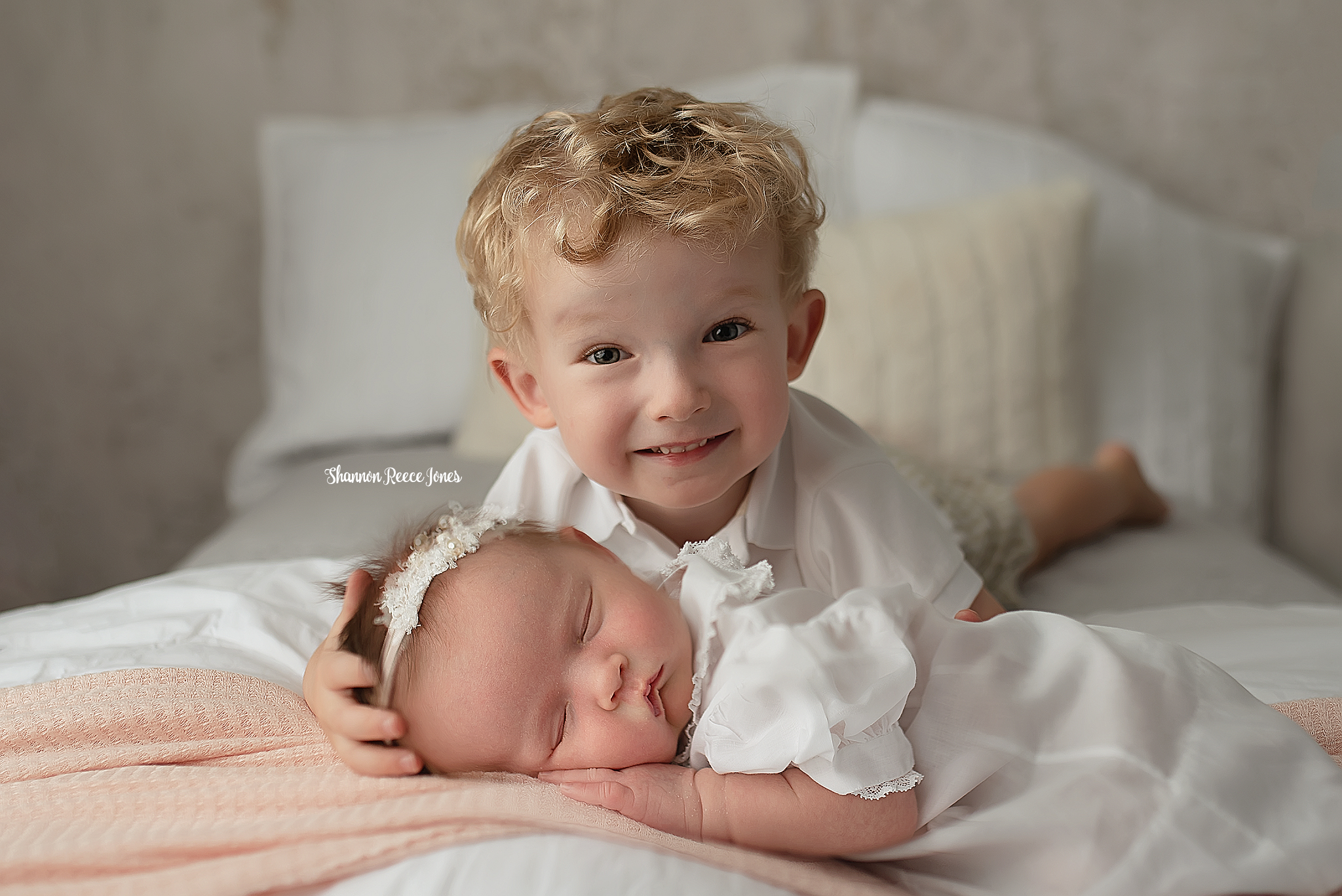 sibling photos, brother lying on bed with baby sister