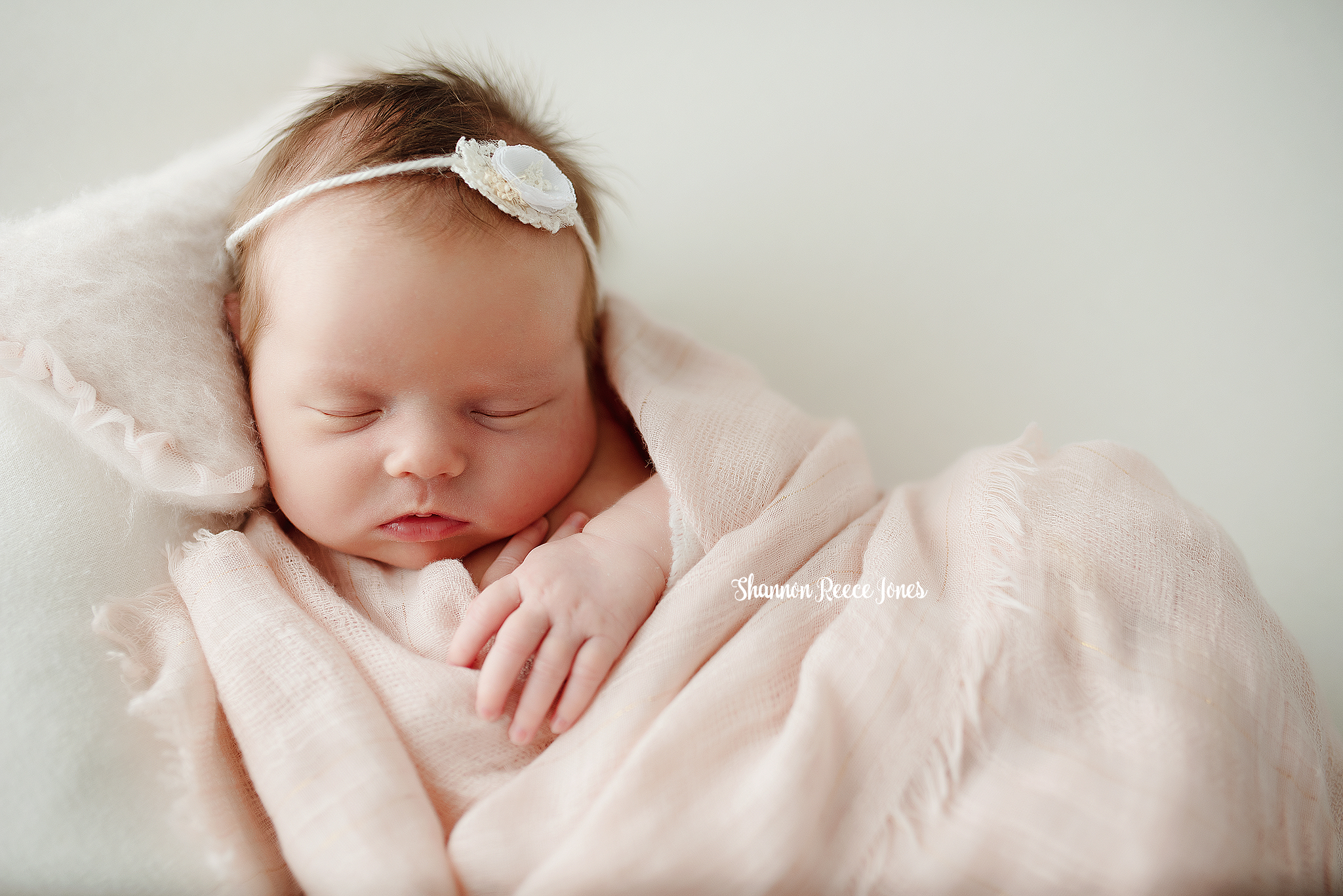 studio newborn photographer tx, baby girl with headband asleep in blankets