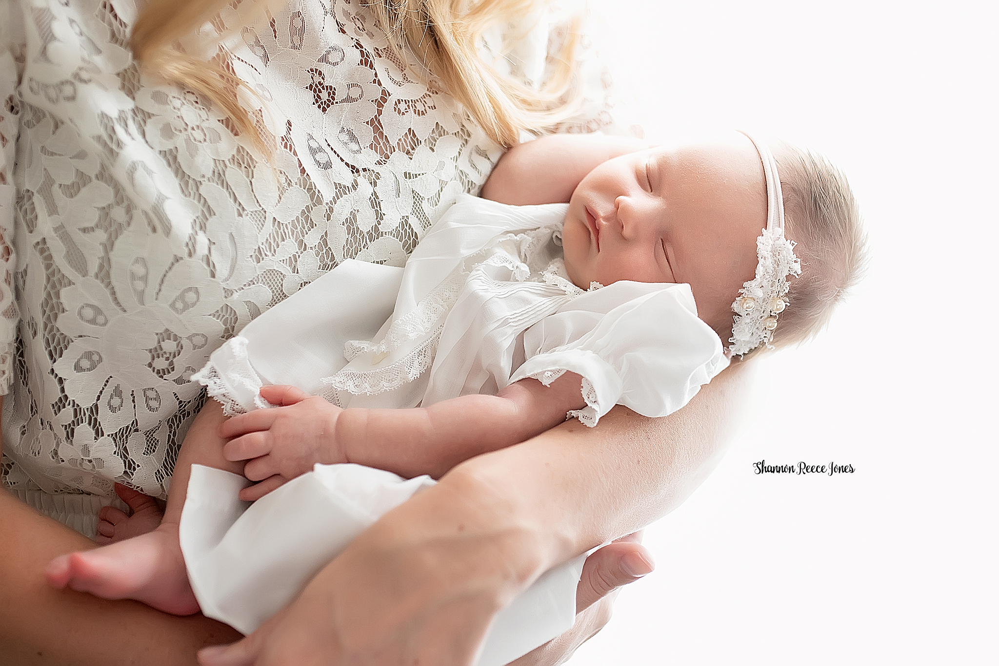 studio newborn photos near me houston, infant girl dressed in white asleep in mom's arms