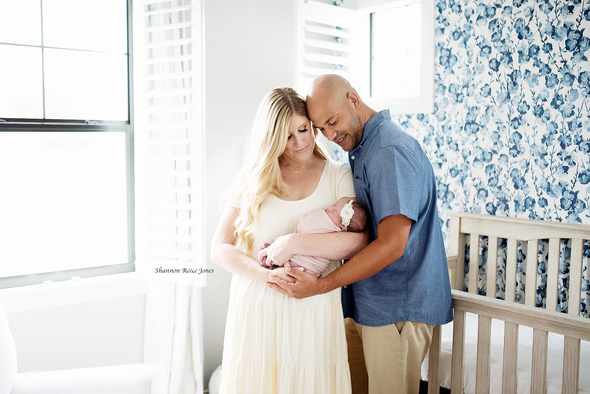 lifestyle newborn photo session tx, mom and dad holding baby in nursery