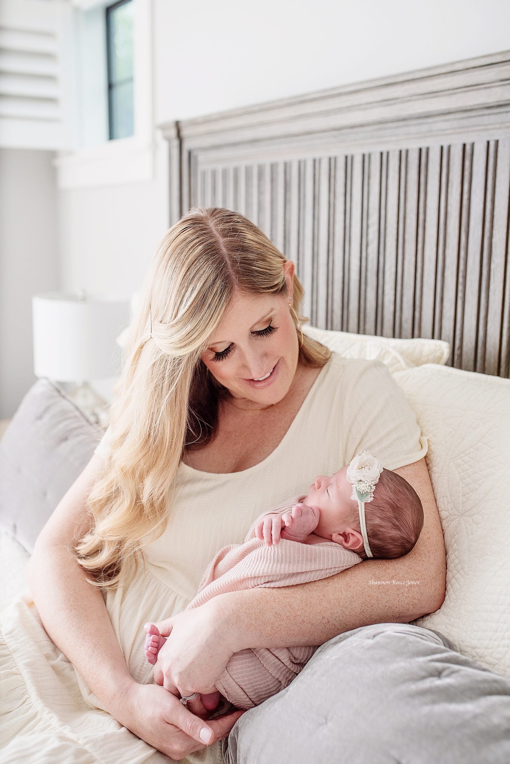 newborn lifestyle session tx, mom and baby on bed