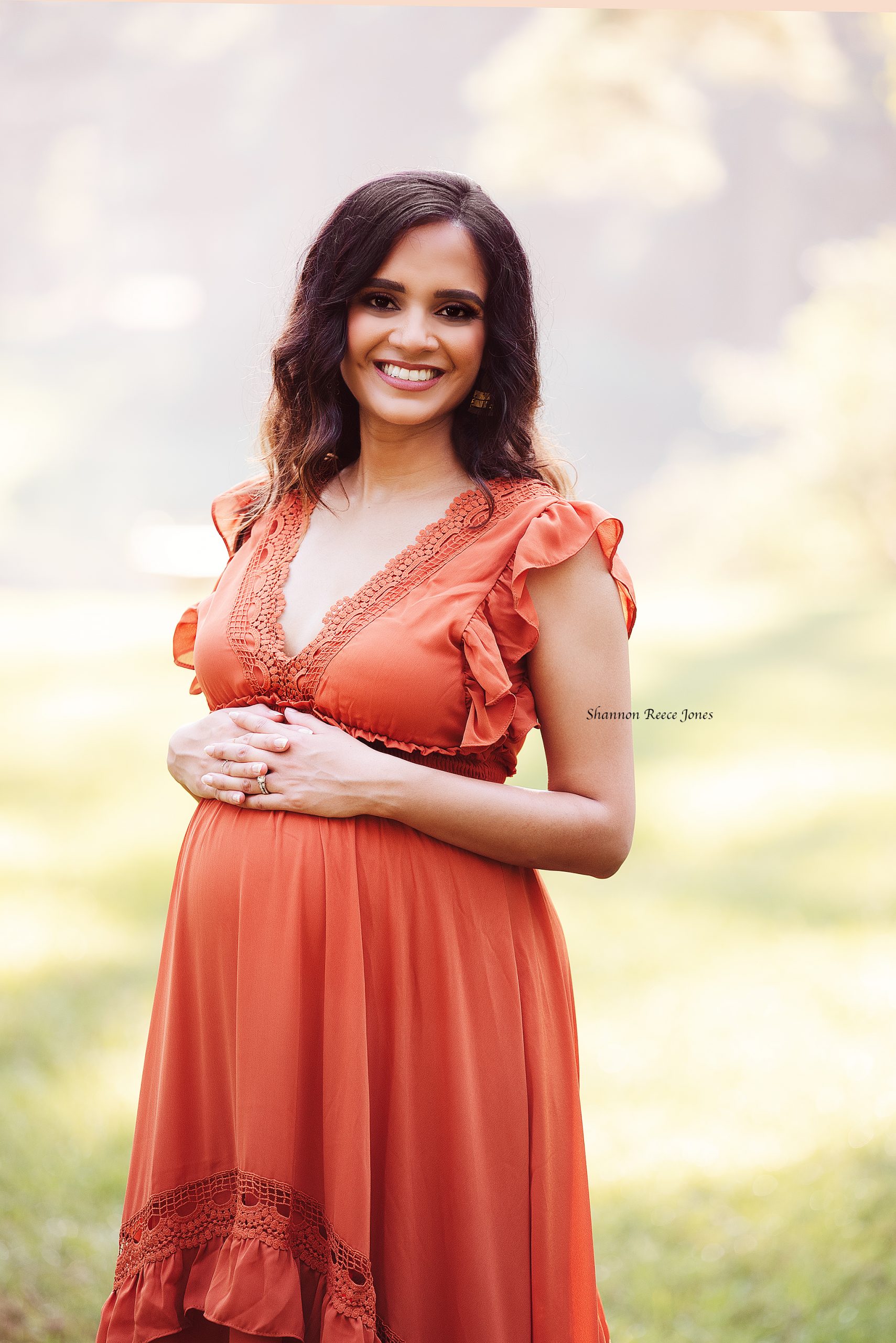 sunrise maternity session, best houston maternity photographers, woman in orange maternity gown outdoors