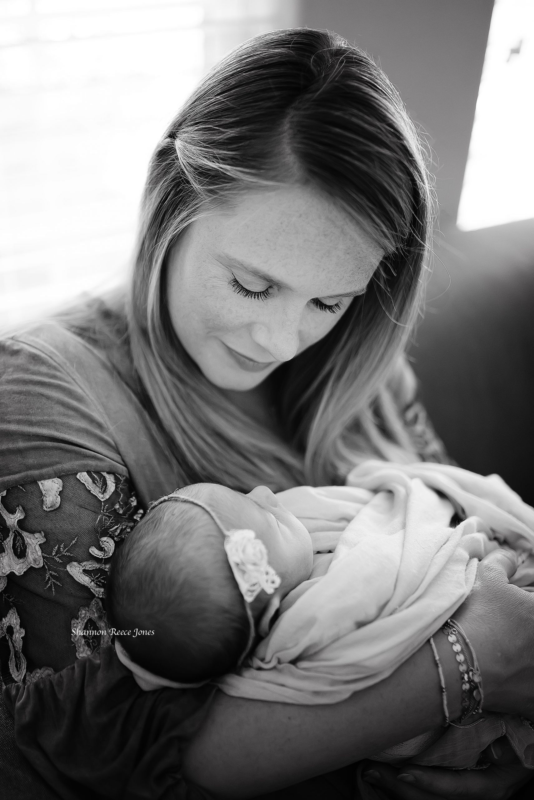 black and white photo of mom holding baby