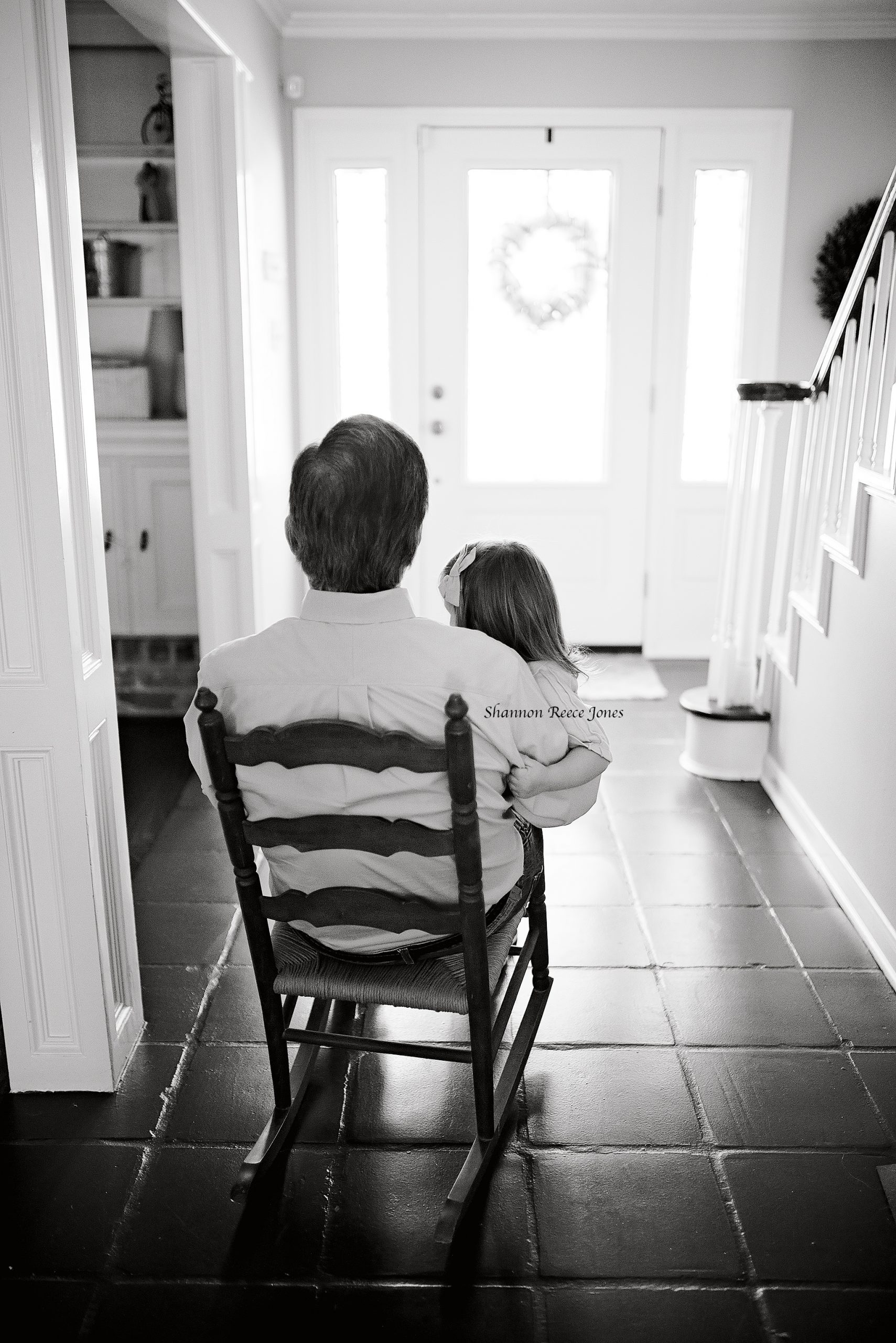 lifestyle photo session, grandpa holding little girl in kitchen rocking chair