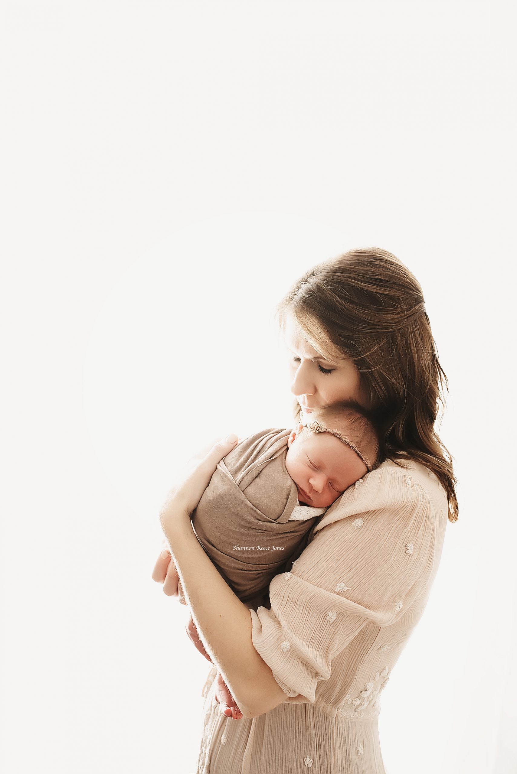 photo of woman holding newborn baby