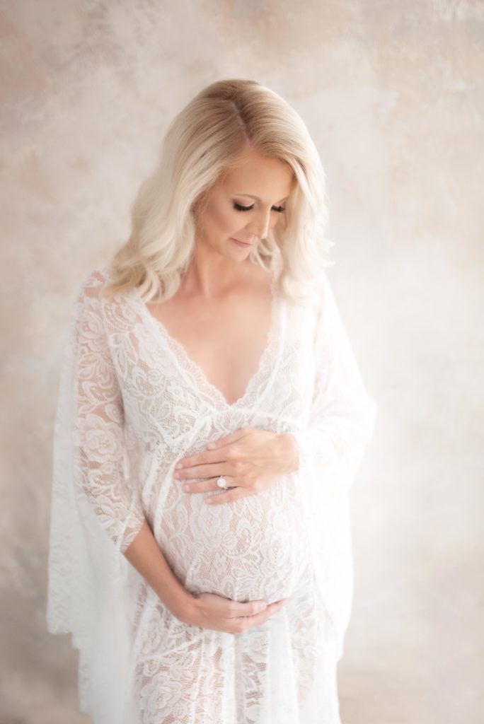 best maternity photography near me the Woodland TX, pregnant woman in white lace gown