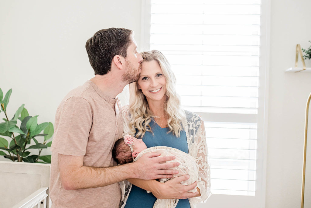 parents with new baby, at home newborn photographer Houston Texas
