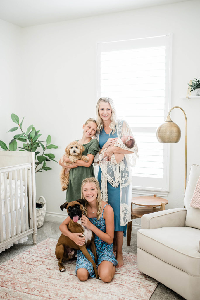 mom and daughters with dogs and baby, at home newborn photographer TX