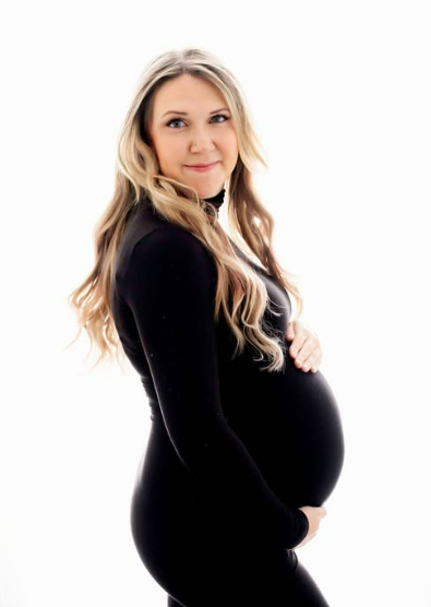 Pregnant mother in fitted black dress during a Houston maternity photoshoot