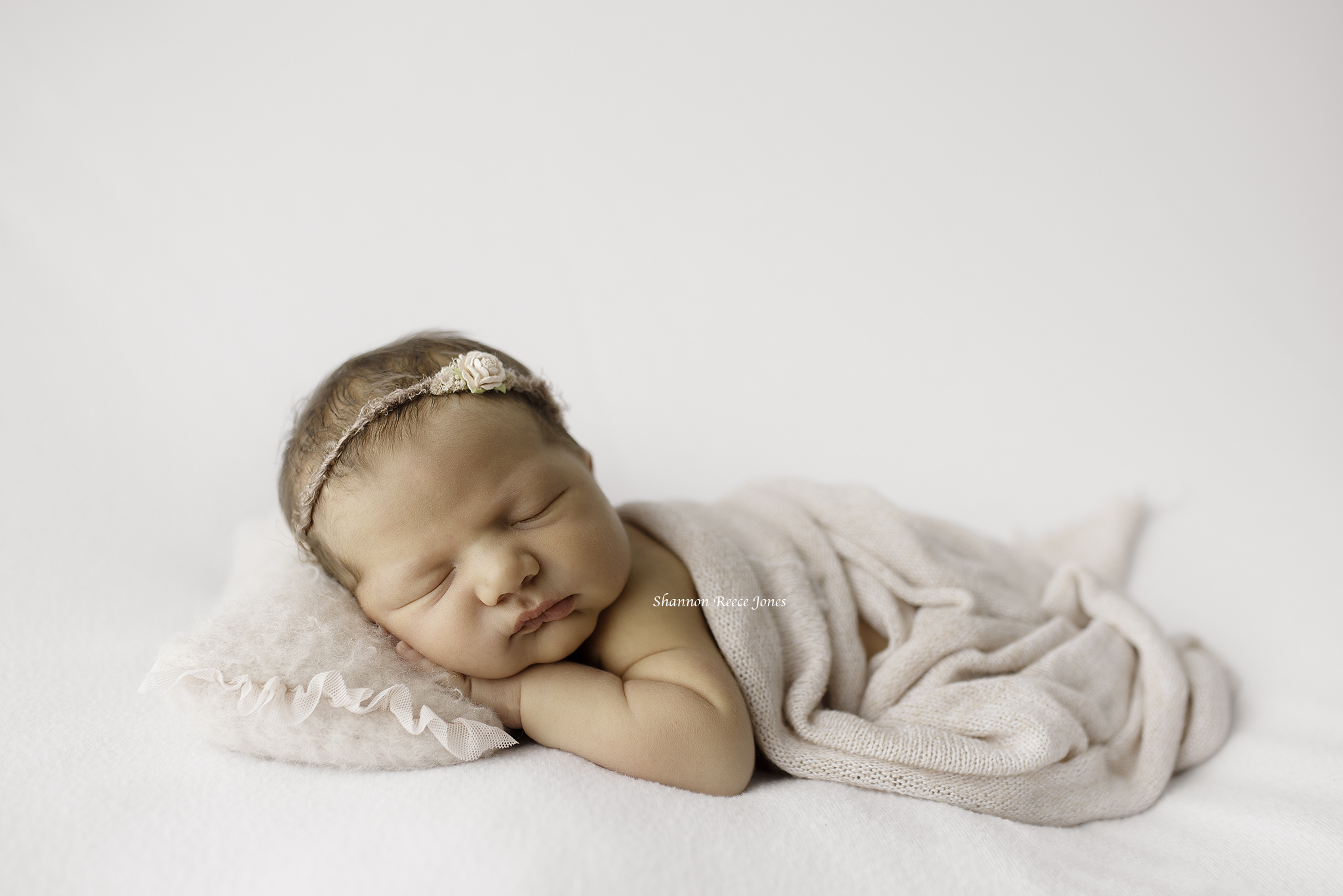 Sleeping newborn girl in Conroe newborn photo studio