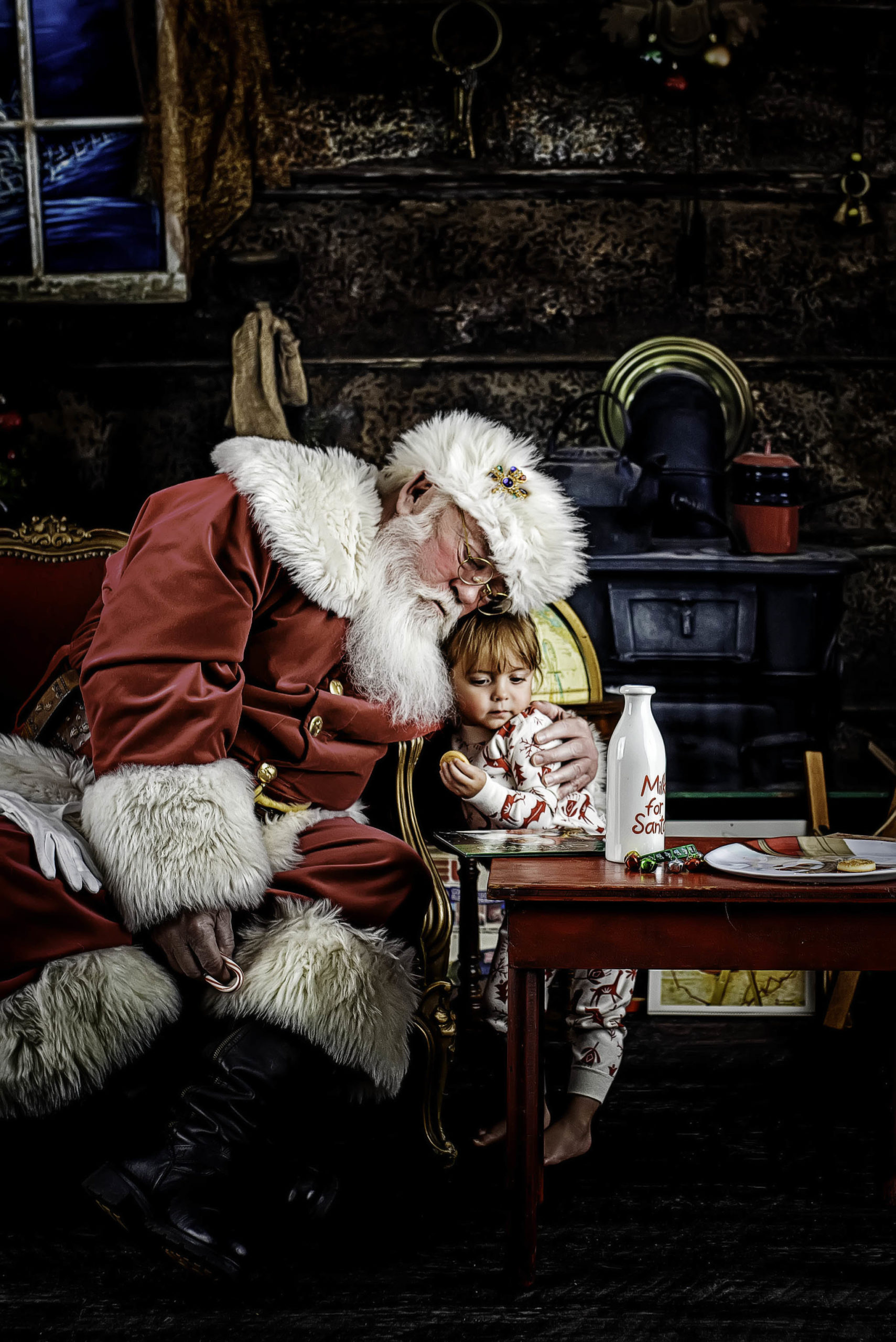 Santa sitting next to child in Houston Texas studio