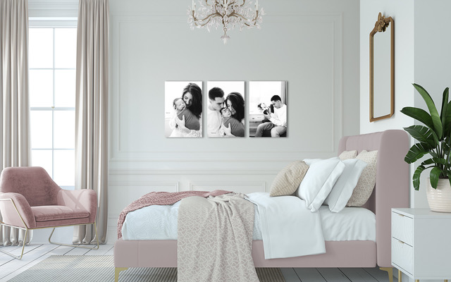 Black and white canvas triptych hung on the wall in a cozy and elegant bedroom