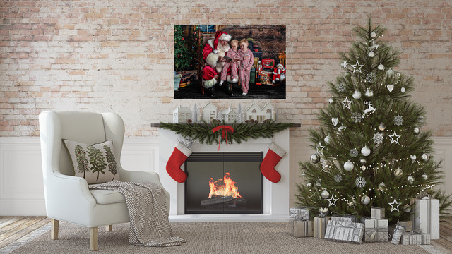 Canvas of Santa and two little boys in red-striped pajamas hung over a festive fireplace next to a Christmas tree