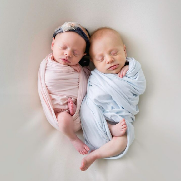 Twins cuddled together in swaddle pose in Houston Texas studio