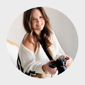 Houston photographer seated on chair holding a camera 