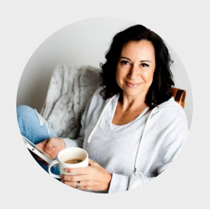 Woman seated in chair holding a cup of coffee