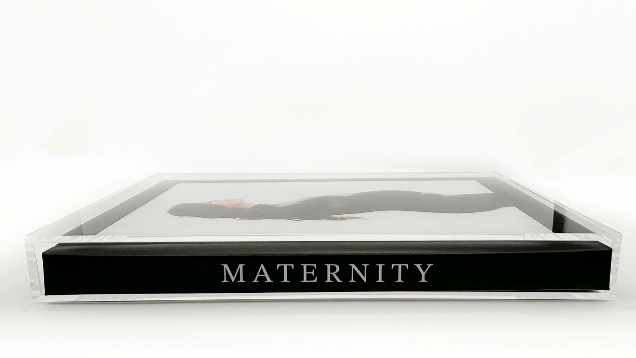 Modern maternity photo album laid on its side to expose the spine