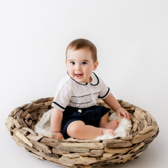 Baby boy in a basket during his 6-month-photoshoot, the perfect age to start music classes for Houston babies and families