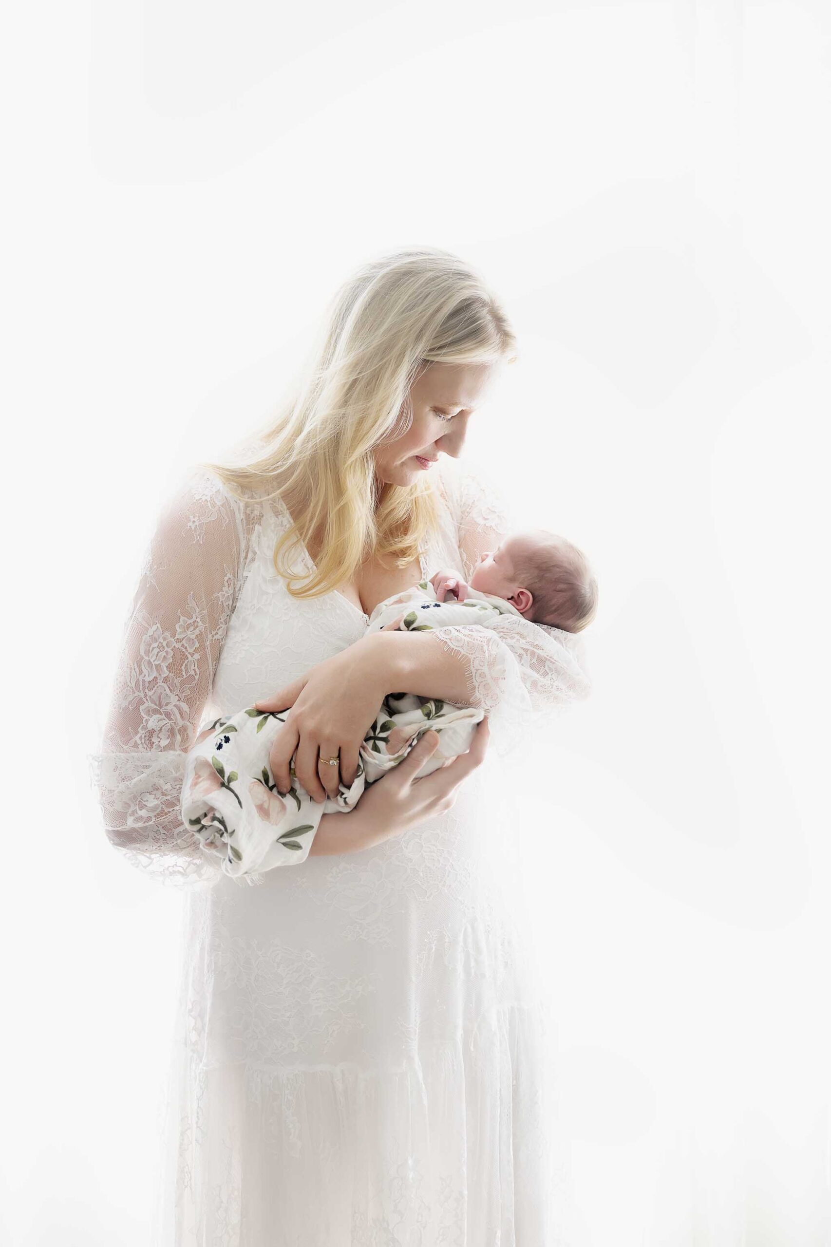 Mom and Baby in White - At home newborn session in front of window.