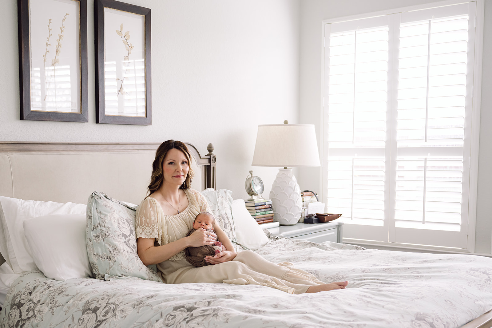 Mom on bed with newborn baby