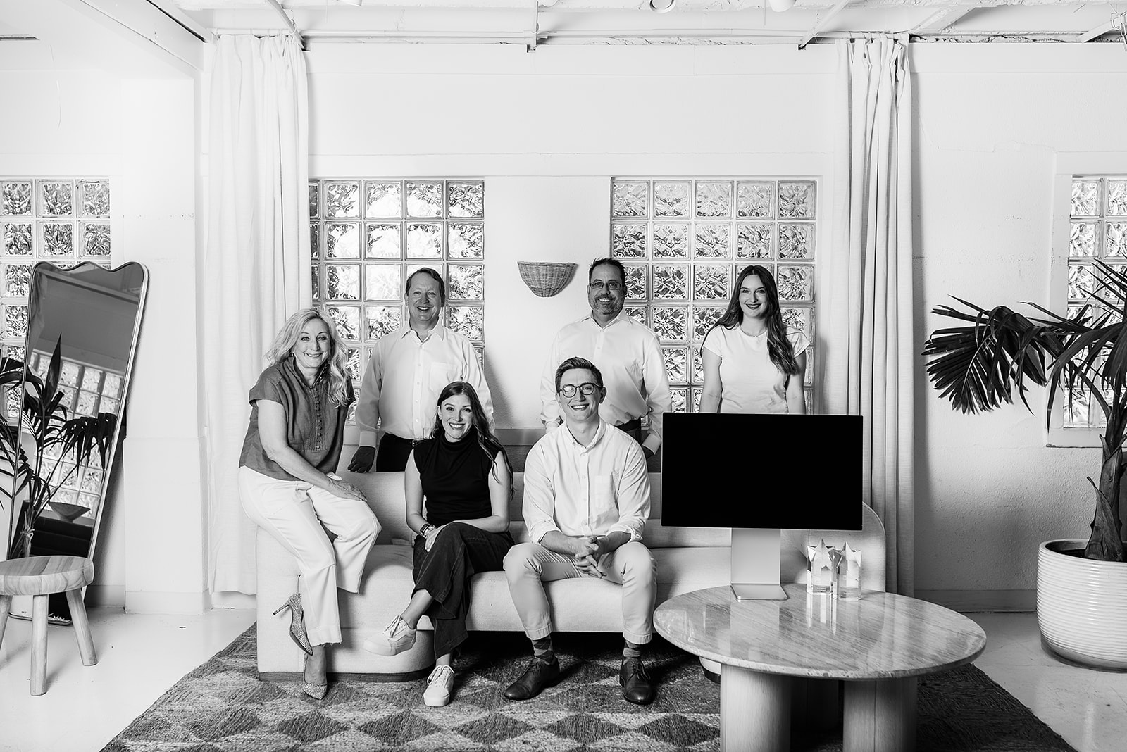 Black and white image showing the company team in the office