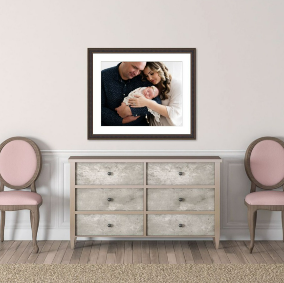 Framed printed portrait of parents with newborn