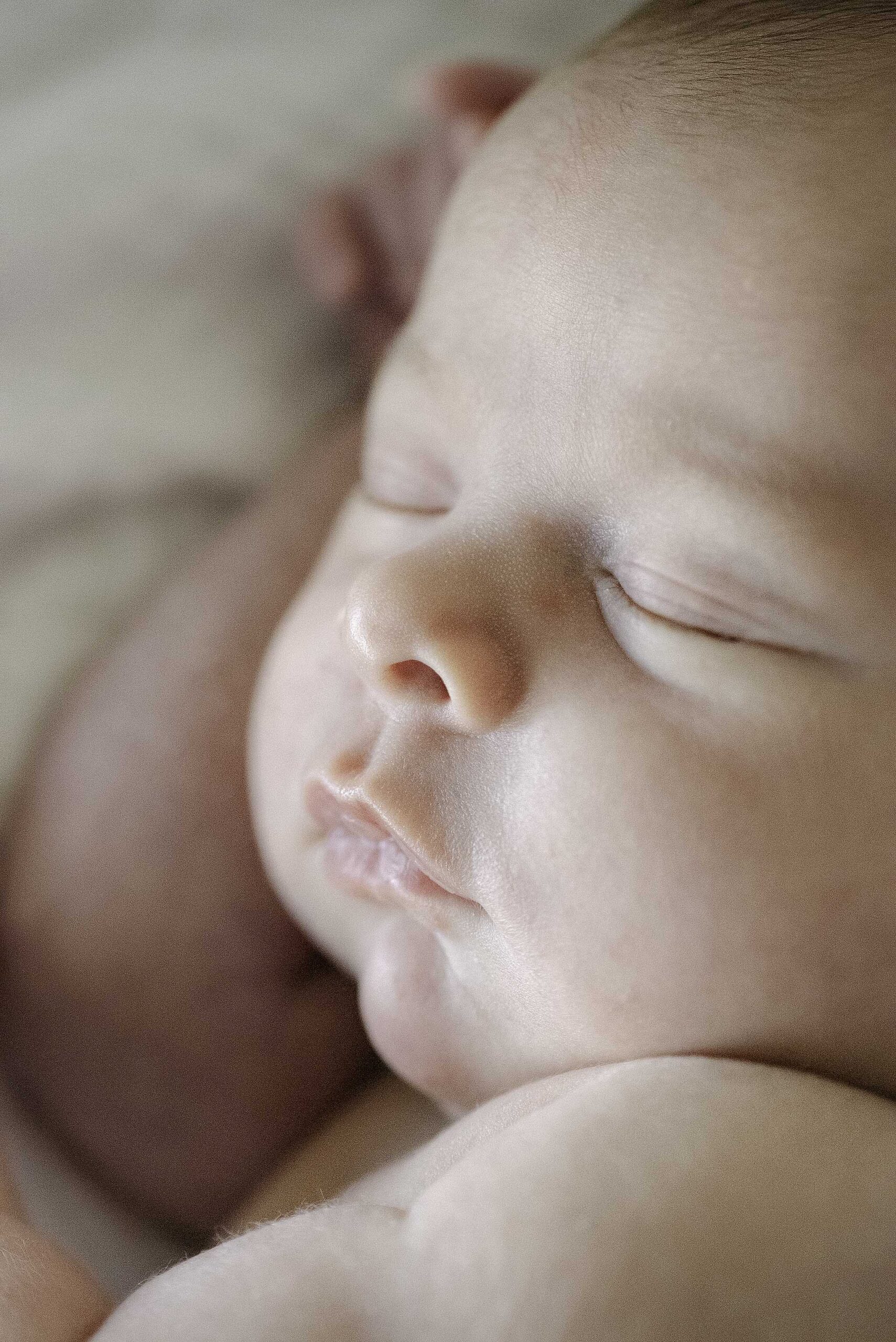 Houston newborn photographer with sleeping newborn baby portrait