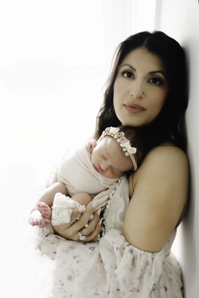 Mother holding newborn during Houston newborn photography session
